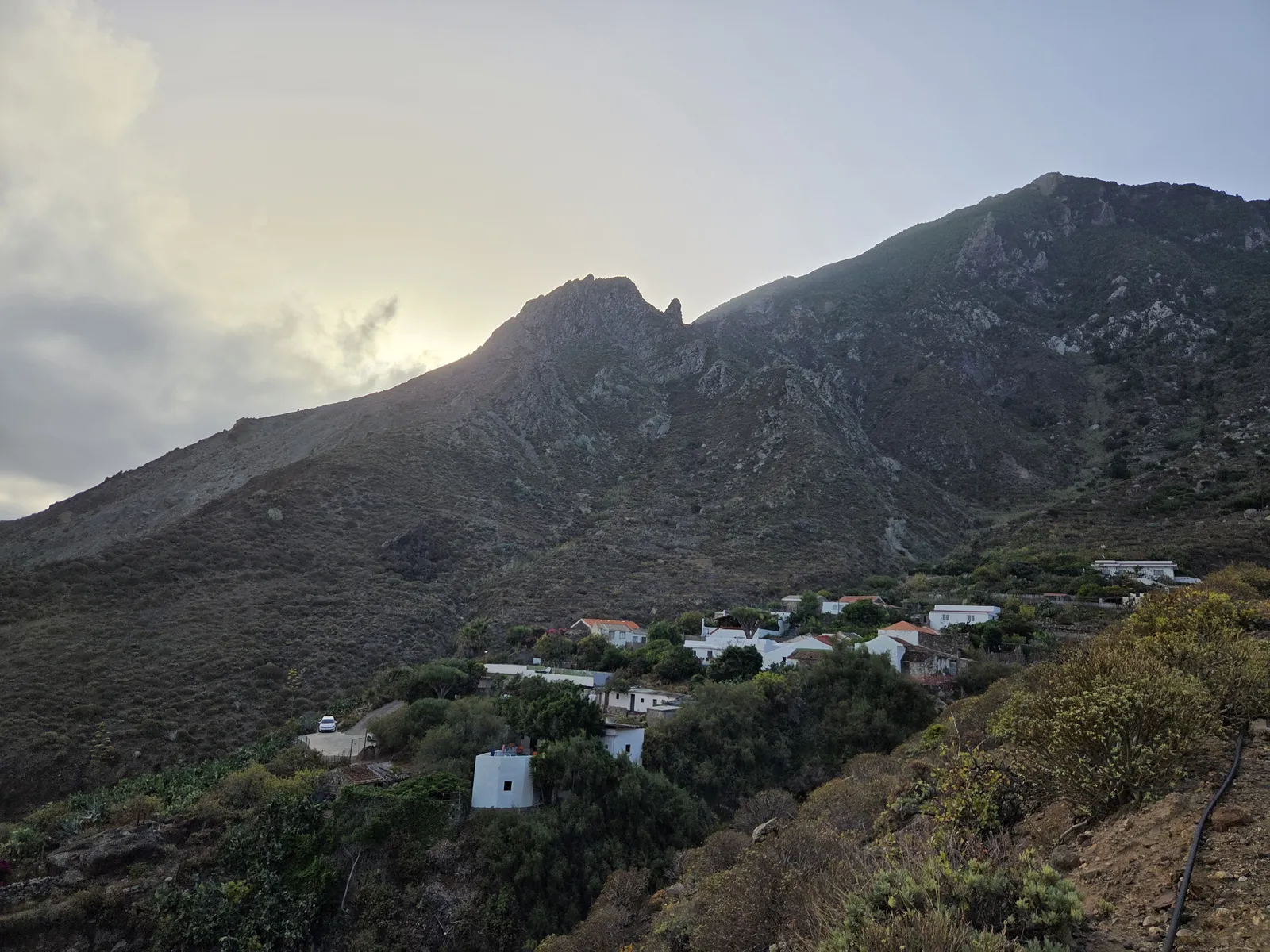 White houses and cultivated terraces of El Draguillo beneath steep mountain ridges