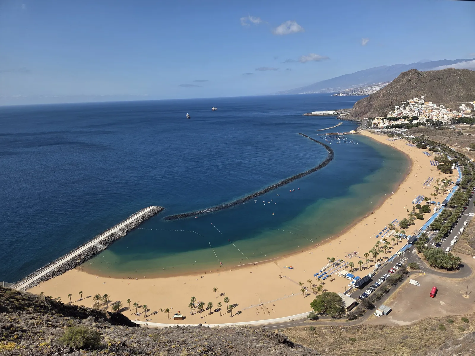 Elevated view of Las Teresitas beach, its curved breakwater and San Andrés beyond