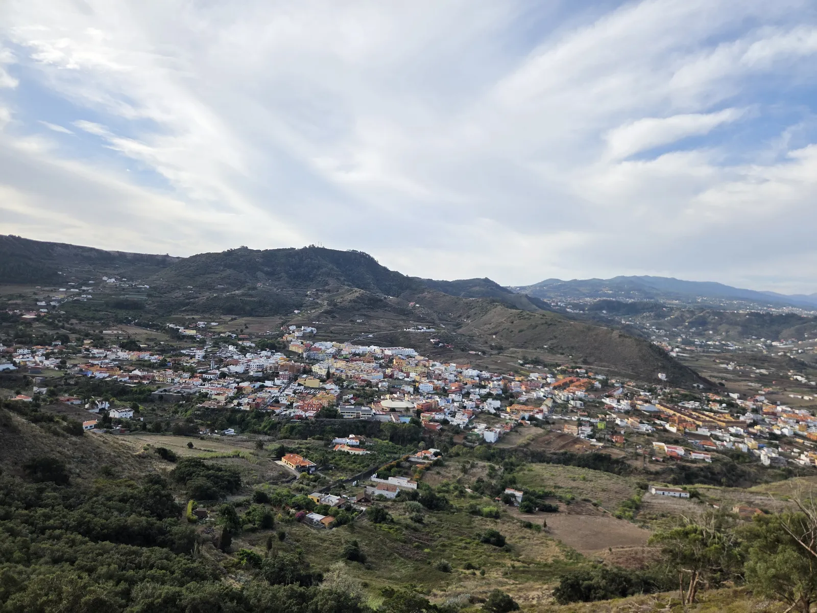 Tegueste’s white houses and cultivated plots spread across a valley beneath dark ridges
