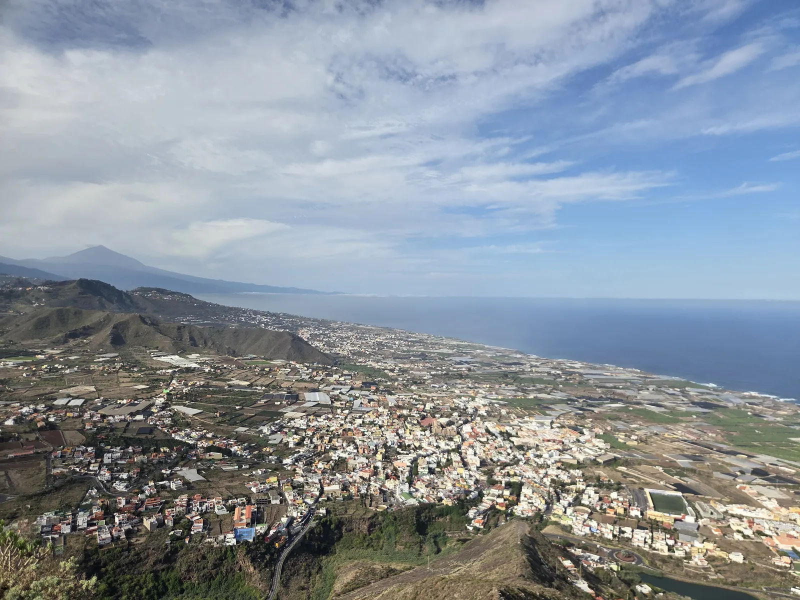 Houses and farmland below Mesa de Tejina, with the Atlantic coast and distant Teide beyond