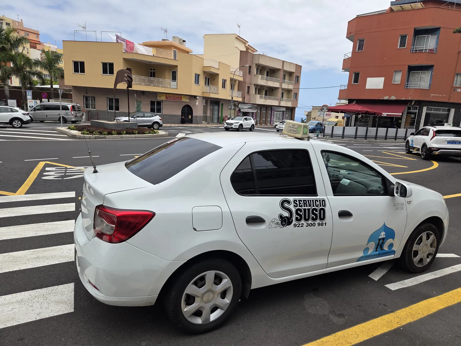 White licensed taxi displaying Los Realejos markings at a street taxi rank